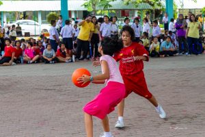 Two girls playing chairball